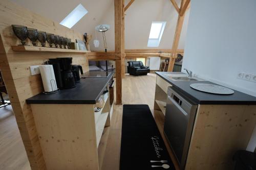 a kitchen with a stove and a counter top at Burg 2 - Ferienwohnungen in Taching am See