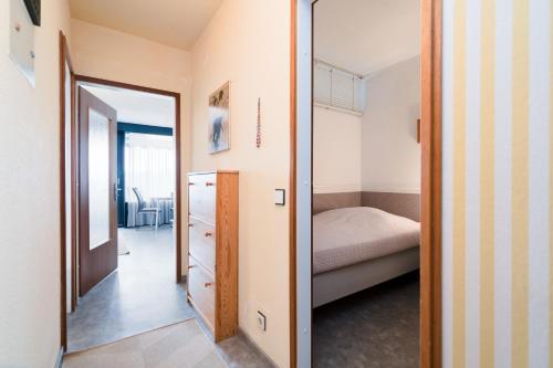 a small bedroom with a bed and a mirror at Ferienpark Sierksdorf App 382 - Strandlage in Sierksdorf