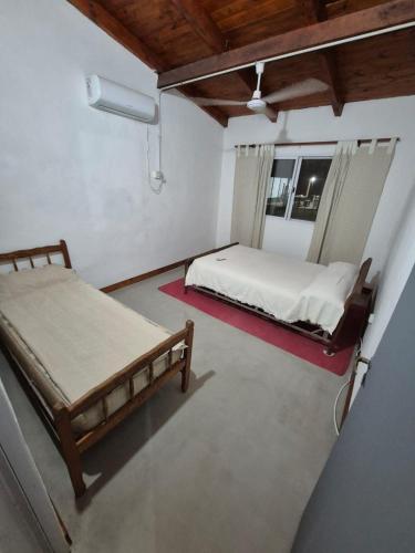 a bedroom with two beds and a window at Chacra mita í in La Cruz