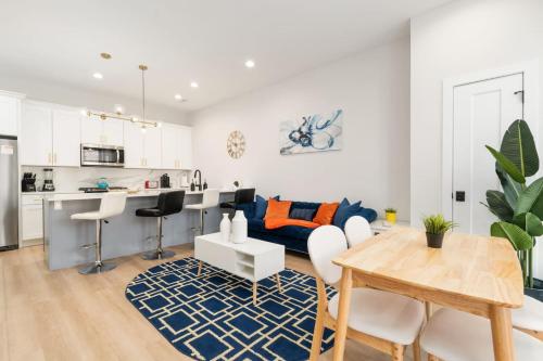 a living room with a blue couch and a table at Gilean Urban Retreat in Chicago