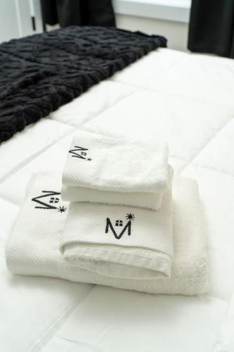 a pile of towels sitting on top of a bed at Gilean Urban Retreat in Chicago