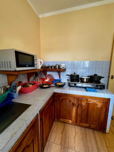 a kitchen with a counter top with pots and pans at Pereybere Beach Apartments in Pereybere