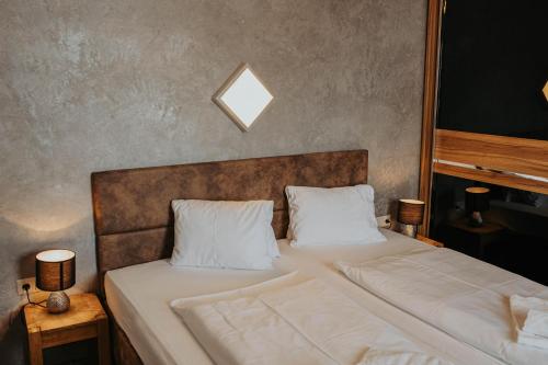 een slaapkamer met een bed met twee witte kussens bij Appartement Conrad in Saalbach Hinterglemm