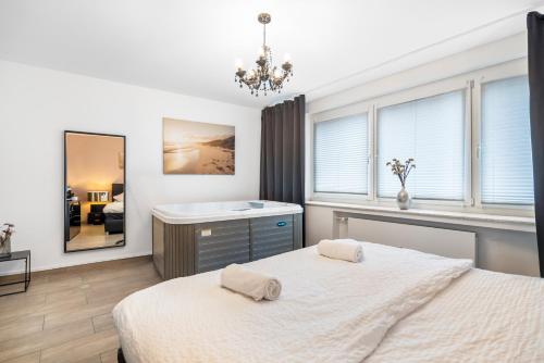 a bedroom with a bed and a sink and a mirror at Urban Retreat Apartment - Whirpool - Top Lage in Cologne