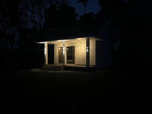 a small building with lights in the dark at Thoniyot Heritage villas in Kalpetta