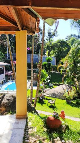 an outside view of a house with a garden at Pousada Pitoresca Casa Amarela in Mairiporã