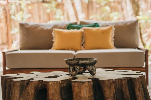 a living room with a couch and a coffee table at Kokoro Mio Hotel & Wellnes in Xul-Ha