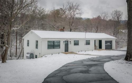 a white house in the snow with a driveway at Time to Wine Down - Family Home in Afton