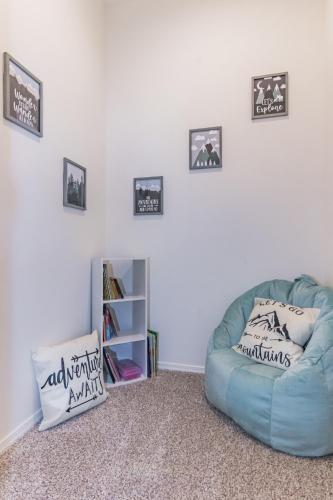 a blue couch in a room with pictures on the wall at Elk Rim 1156 Pine in Pine