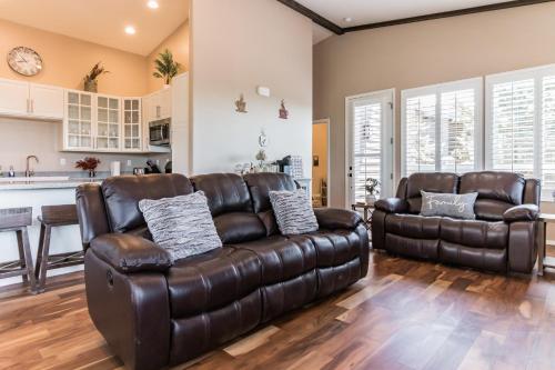 a living room with a leather couch and two chairs at Elk Rim 1156 Pine in Pine