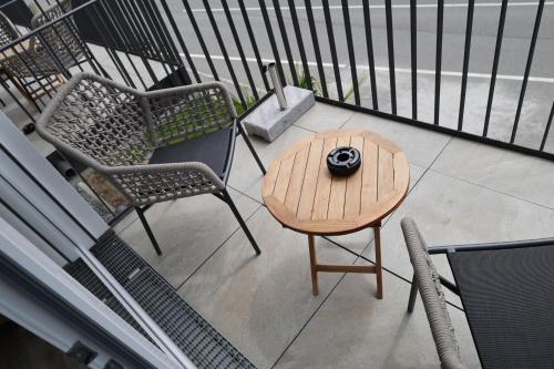 a small table and two chairs on a balcony at MEIN MOTEL - Self Check-in in Oberndorf am Neckar