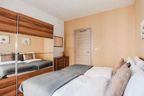 a bedroom with two beds and a closet at BH - Three Bedroom Apartment in Sliema