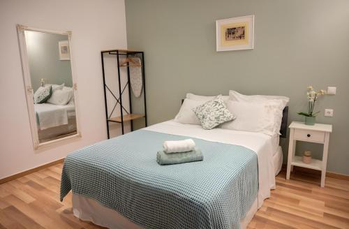 a bedroom with a large bed with a mirror at Cloe Corfu Town Apartment in Agios Rokkos