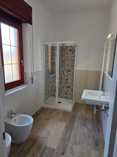 a bathroom with a shower and a toilet and a sink at THAT'S LOVE Fiumicino Jazz in Fiumicino