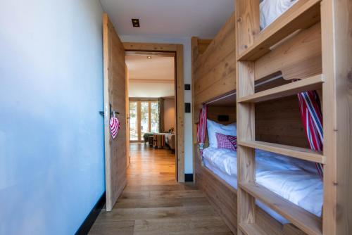 a hallway with bunk beds in a house at Chalet Myriam in Grächen