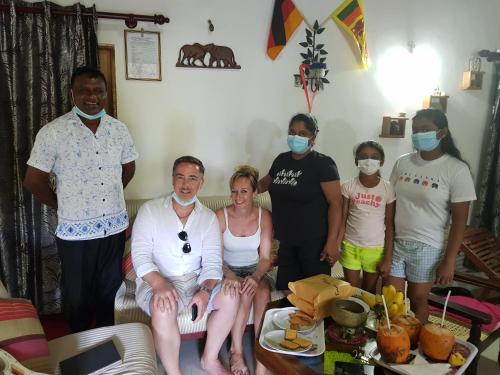 a group of people wearing face masks in a living room at The villa sunshine kadawala in Dunagaha