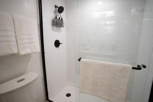 a bathroom with a shower with a toilet and a towel at Salt City Loft in Salt Lake City