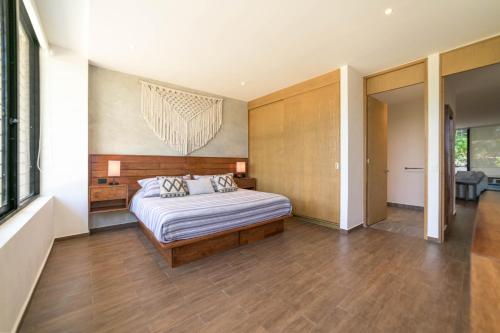 a bedroom with a bed in a room at Modern Condo 200m from Beach & 5th Ave in Playa del Carmen