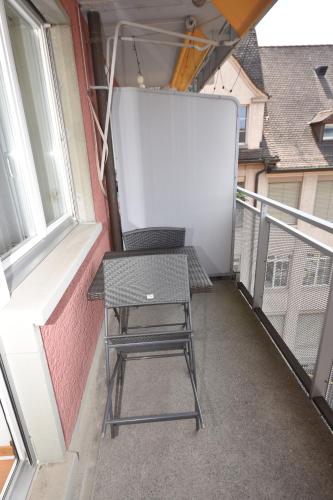 a chair sitting on a balcony with a whiteboard at Cozy studio in the city center - Mill 532 in Zürich