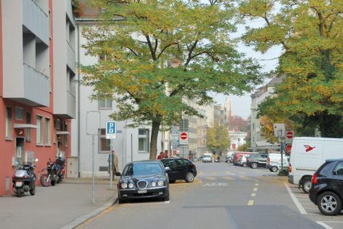 a car parked on the side of a city street at Cozy studio in the city center - Mill 532 in Zürich