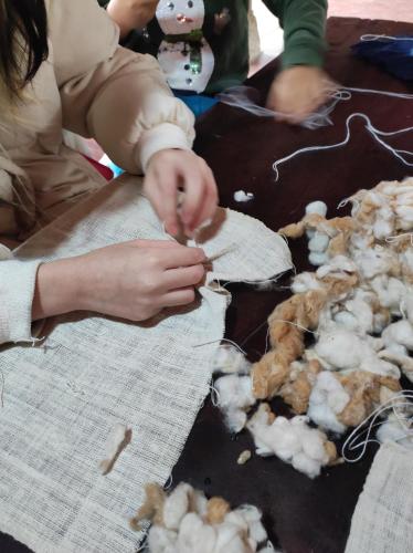 a person cutting up a stuffed animal on a table at Little House in KhauPha, Mu Cang Chai - homestay, cuisine, cafe in Mù Cang Chải