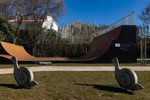 a skate park with a skateboard ramp and two swans sculptures at Hygge Living Santa Cruz Beachfront in Santa Cruz
