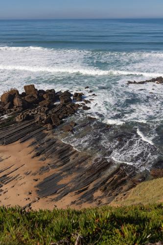 a beach with rocks and the ocean at Hygge Living Santa Cruz Beachfront in Santa Cruz
