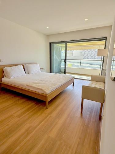 a bedroom with a large bed and a large window at Hygge Living Santa Cruz Beachfront in Santa Cruz