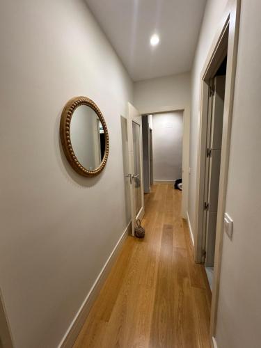 a hallway with a mirror on a wall at Alonso Quijano in Alcalá de Henares