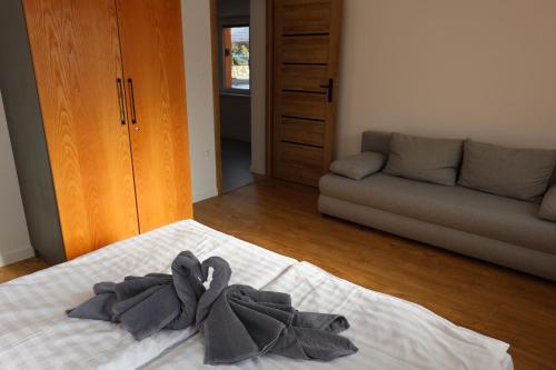 a bedroom with a bed with towels on it at Apartmán Greywood in Vitanová
