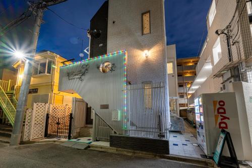 a building with a staircase on the side of it at Papillon Paradis Nishi-Shinjuku in Tokyo