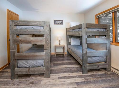 two bunk beds in a room with a window at Greenbrier Townhouse #25 in Avon