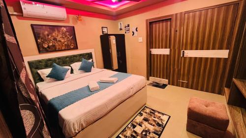 a bedroom with a large bed with blue pillows at Phoenix Nest Homestay in Guwahati