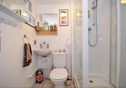 a bathroom with a shower and a toilet and a sink at 3bedroom Sleeps8 Parking FamilyFriendly NearExcel in London