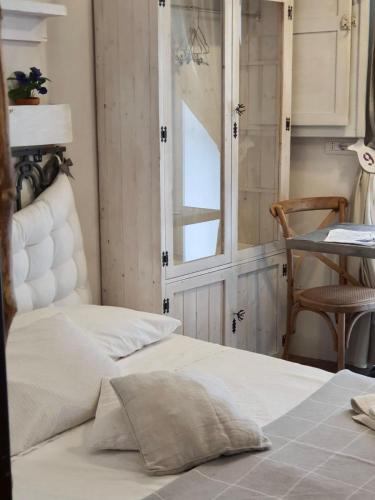 a bedroom with two beds and a table and a window at Marè Rooms Bari old town center in Bari