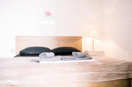 a bedroom with a bed with towels on it at LaPlayaSuites 1st in Periyiálion