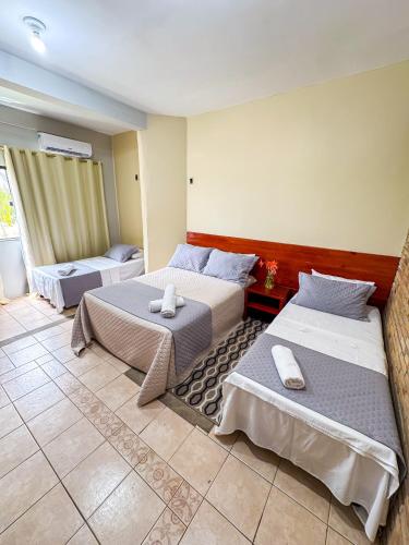 a bedroom with two beds in a room at Hotel Pousada Do Lago in Campo Maior