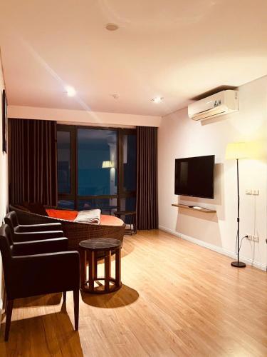 a living room with a couch and a television at Emoi Mipec Riverside's Apt in Hanoi