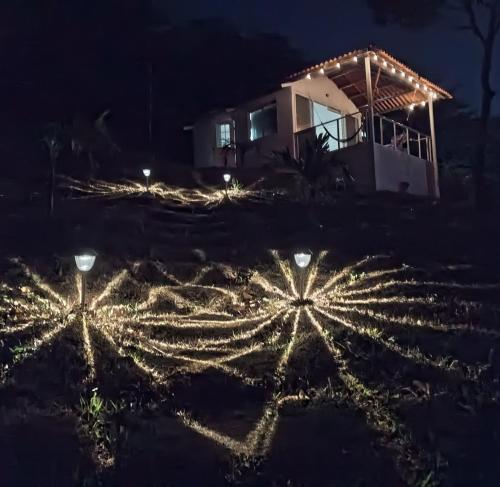 a house decorated with christmas lights at night at Cabañas Laguna Bella - Bella in San Carlos