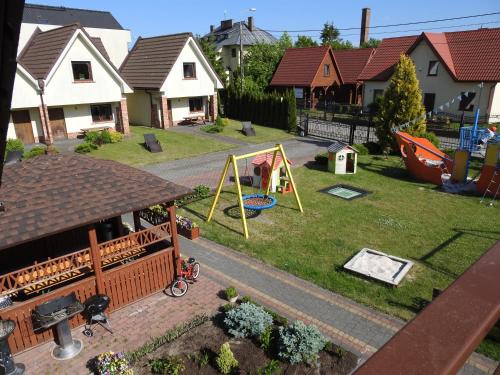 a toy yard with a playground in a house at Elizabeth Łeba - Pokoje Gościnne in Łeba