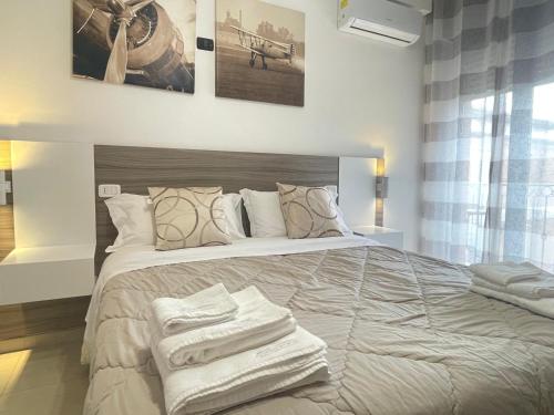 a bedroom with a large bed with towels on it at B&B CORSO ROMA Room Suite & Spa in Apricena