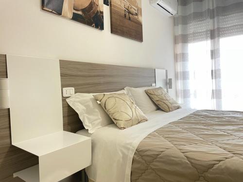 a white bedroom with a bed and a white table at B&B CORSO ROMA Room Suite & Spa in Apricena