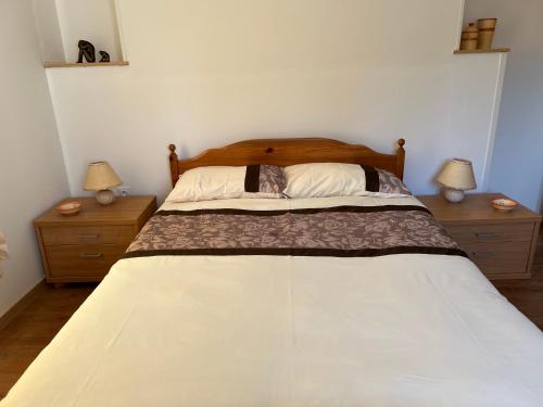 a bedroom with a large bed with two night stands at Chez Casa in Sourdeval