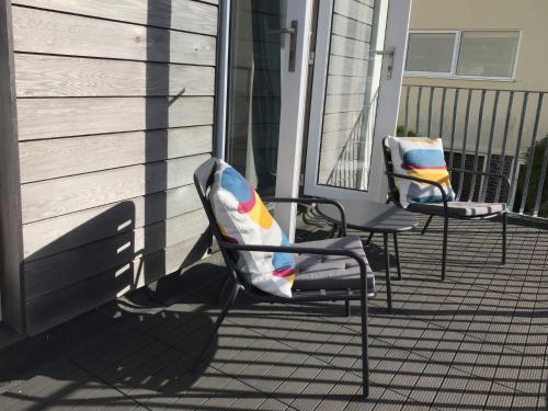 two chairs sitting on the front porch of a house at 6 Inveravon in Christchurch