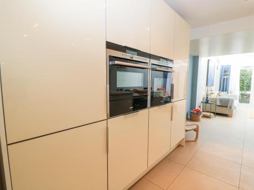 a large white cabinet with a television in a living room at 6 Inveravon in Christchurch