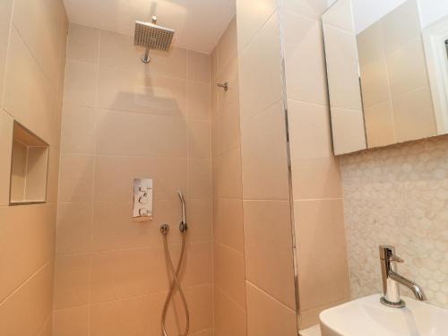 a bathroom with a shower and a sink at 6 Inveravon in Christchurch