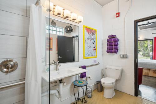 a bathroom with a sink and a toilet at Boutique Vera Hotel in the Heart of Folly Beach in Folly Beach