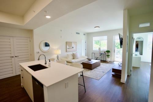 a kitchen and living room with a couch and a table at Ivory at Aviara East Pompano in Pompano Beach