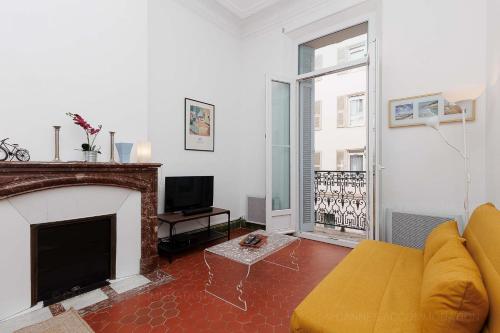 un salon avec un canapé et une cheminée dans l'établissement Bessons, à Cannes