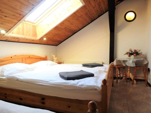 a bedroom with a large bed with a skylight at Elizabeth Łeba - Pokoje Gościnne in Łeba